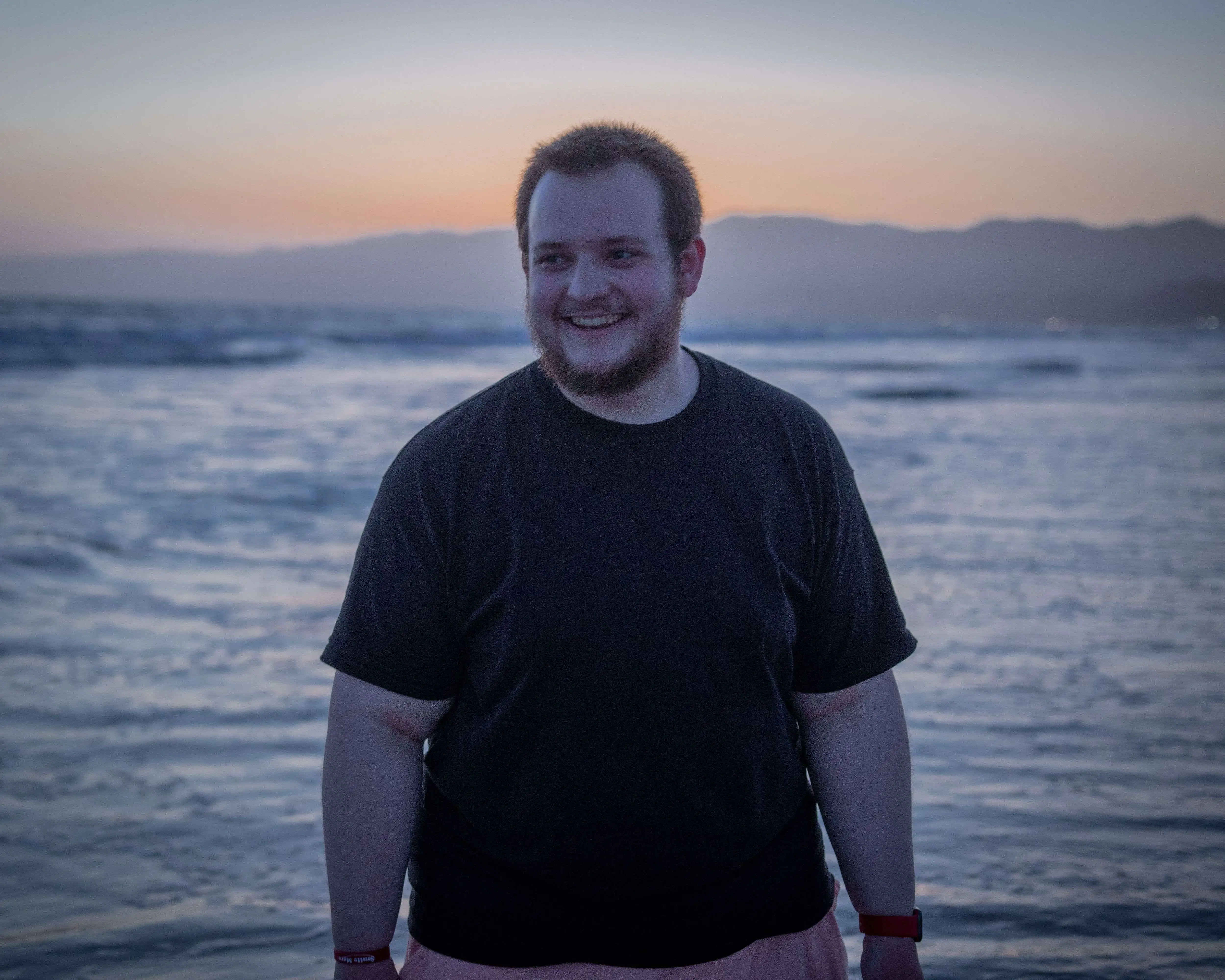 Dan on the The Santa Monica State Beach with water and mountains in the background